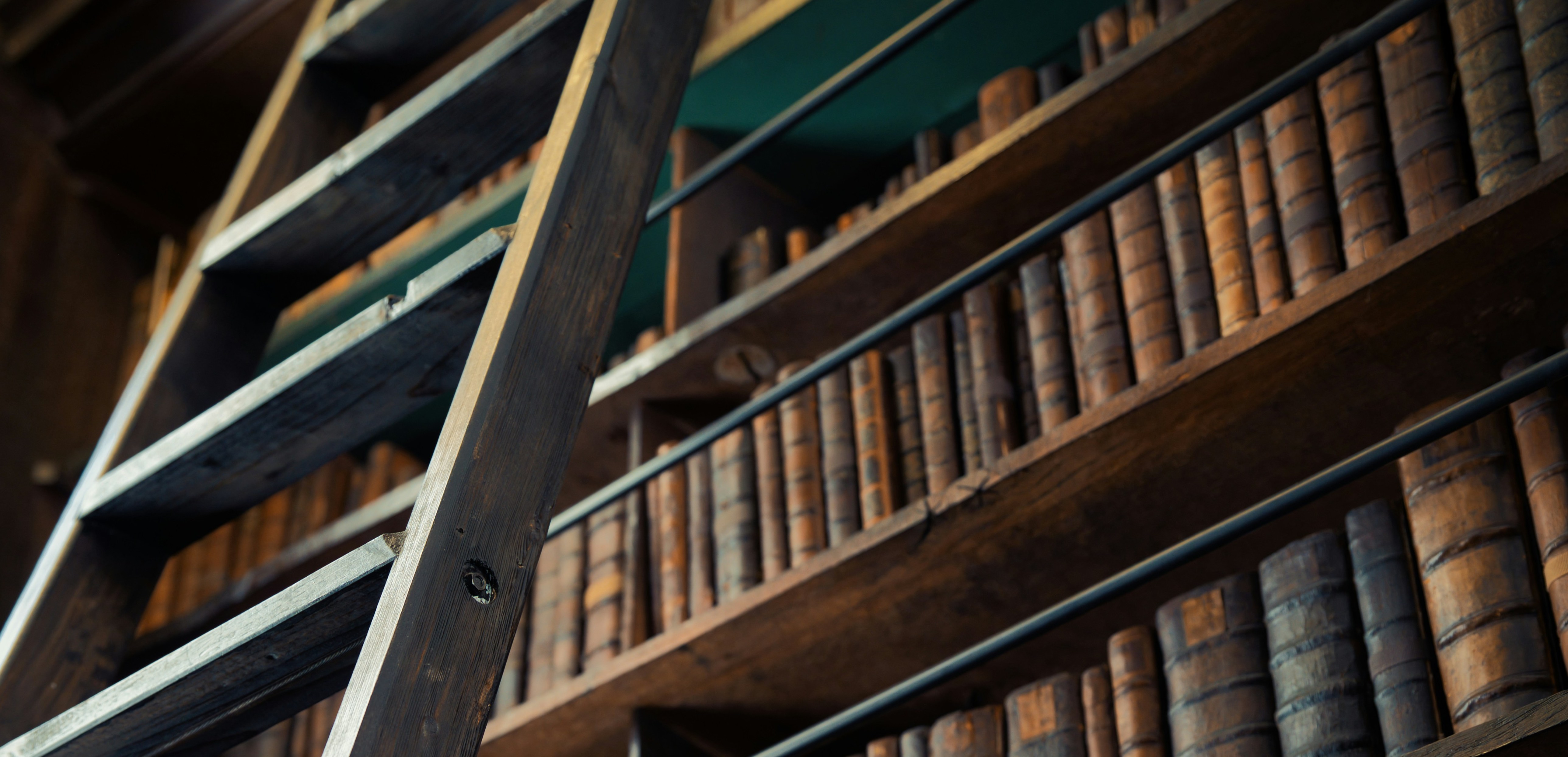 book ladder propped against bookshelf